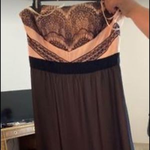 This is a floor length formal gown that is strapless.